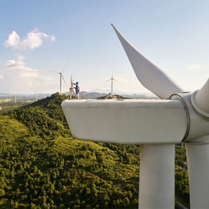 Close up of wind turbine with mountains behind